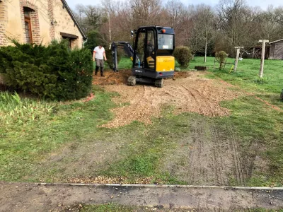 Travaux de terrassement avec mini-pelle dans un jardin